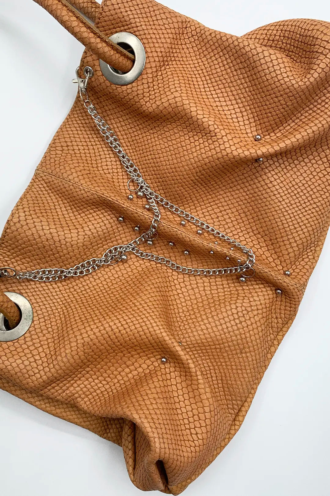 genuine leather pierced bag with chains in amber colour