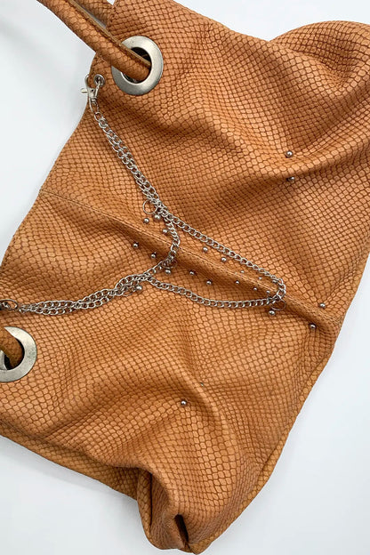 genuine leather pierced bag with chains in amber colour