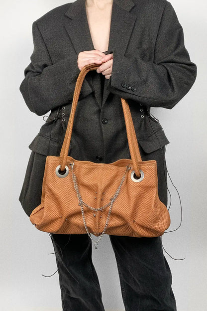 genuine leather pierced bag with chains in amber colour