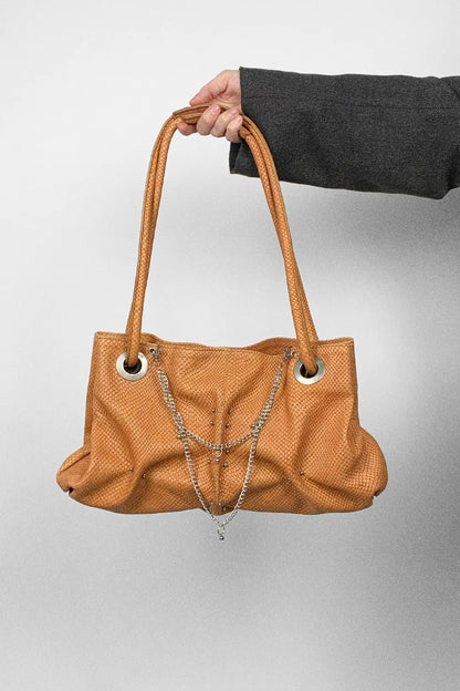 genuine leather pierced bag with chains in amber colour