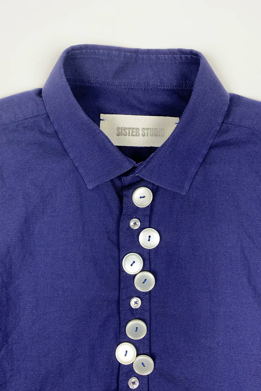 blue cotton shirt with beige buttons and Sister Studio label