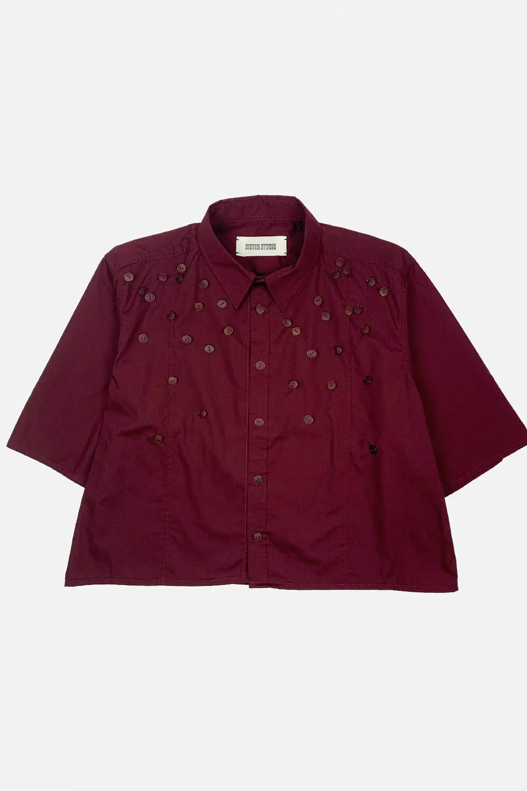 Burgundy shirt with decorative buttons on a white background