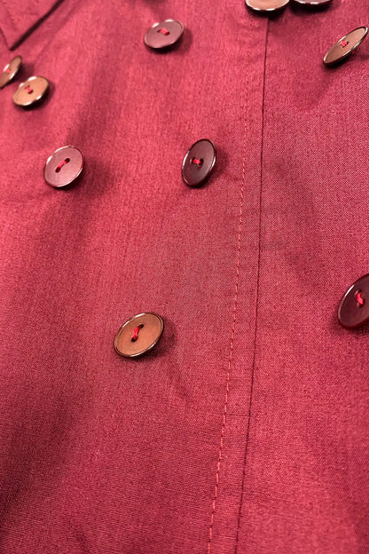 Close-up of a burgundy cotton fabric with buttons 