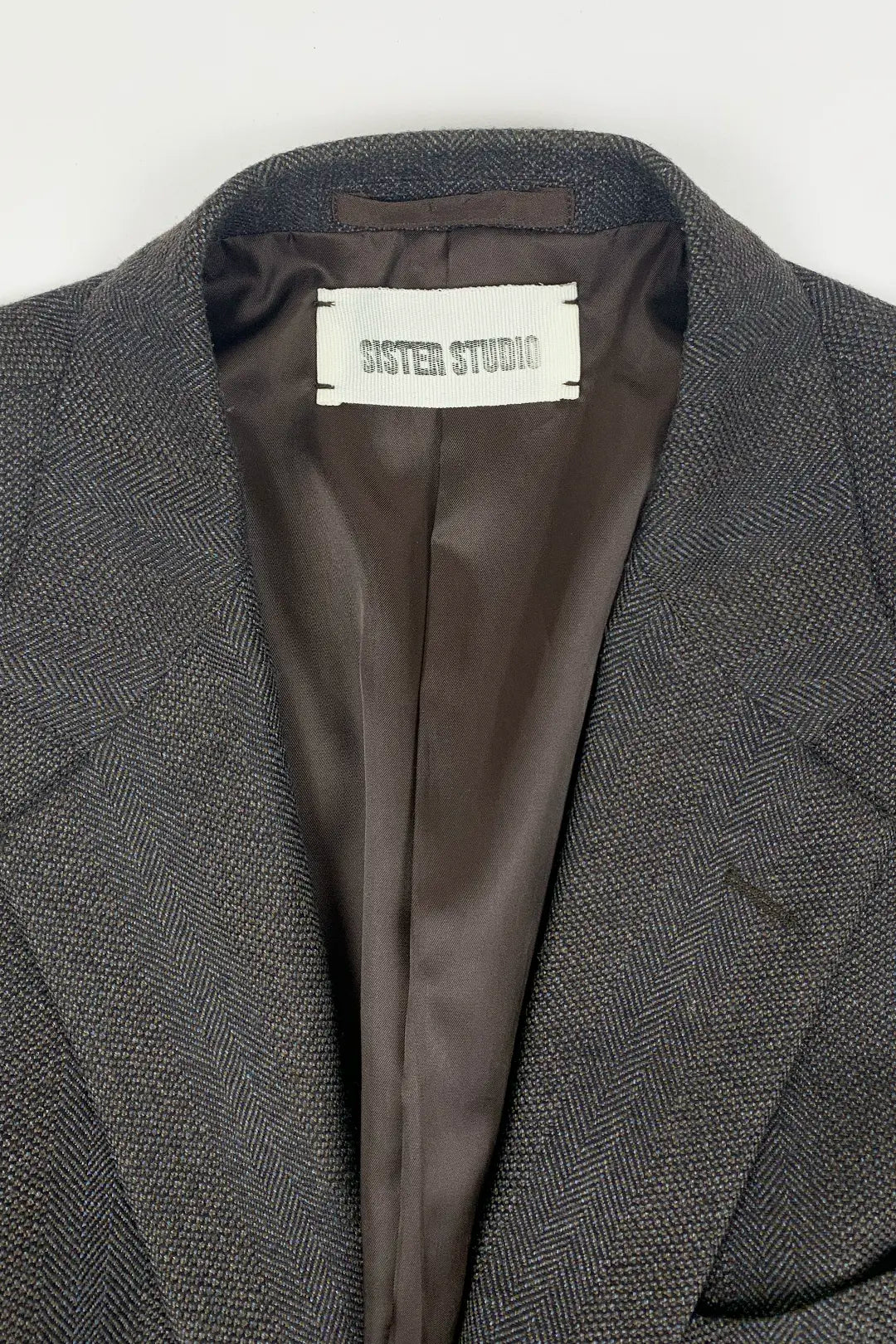 brown blazer with SISTER STUDIO label on a white background