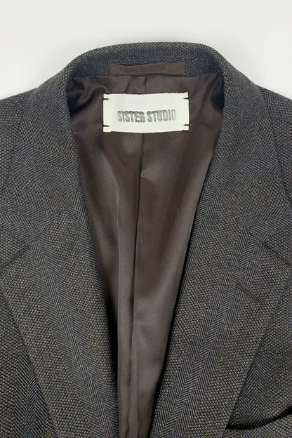 brown blazer with SISTER STUDIO label on a white background