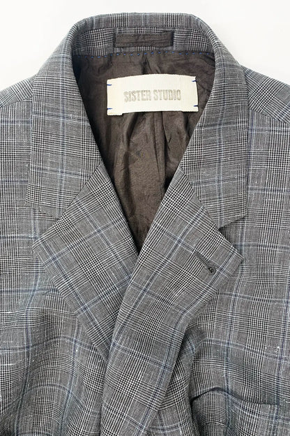 Gray checkered blazer with 'Sister Studio' label on a white background