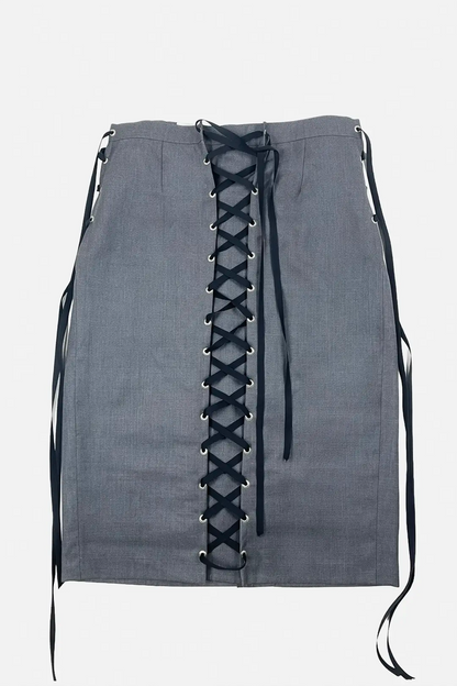 A gray linen-textured mini skirt featuring a prominent black lace-up front closure with silver metal eyelets, shown against a plain light gray background.