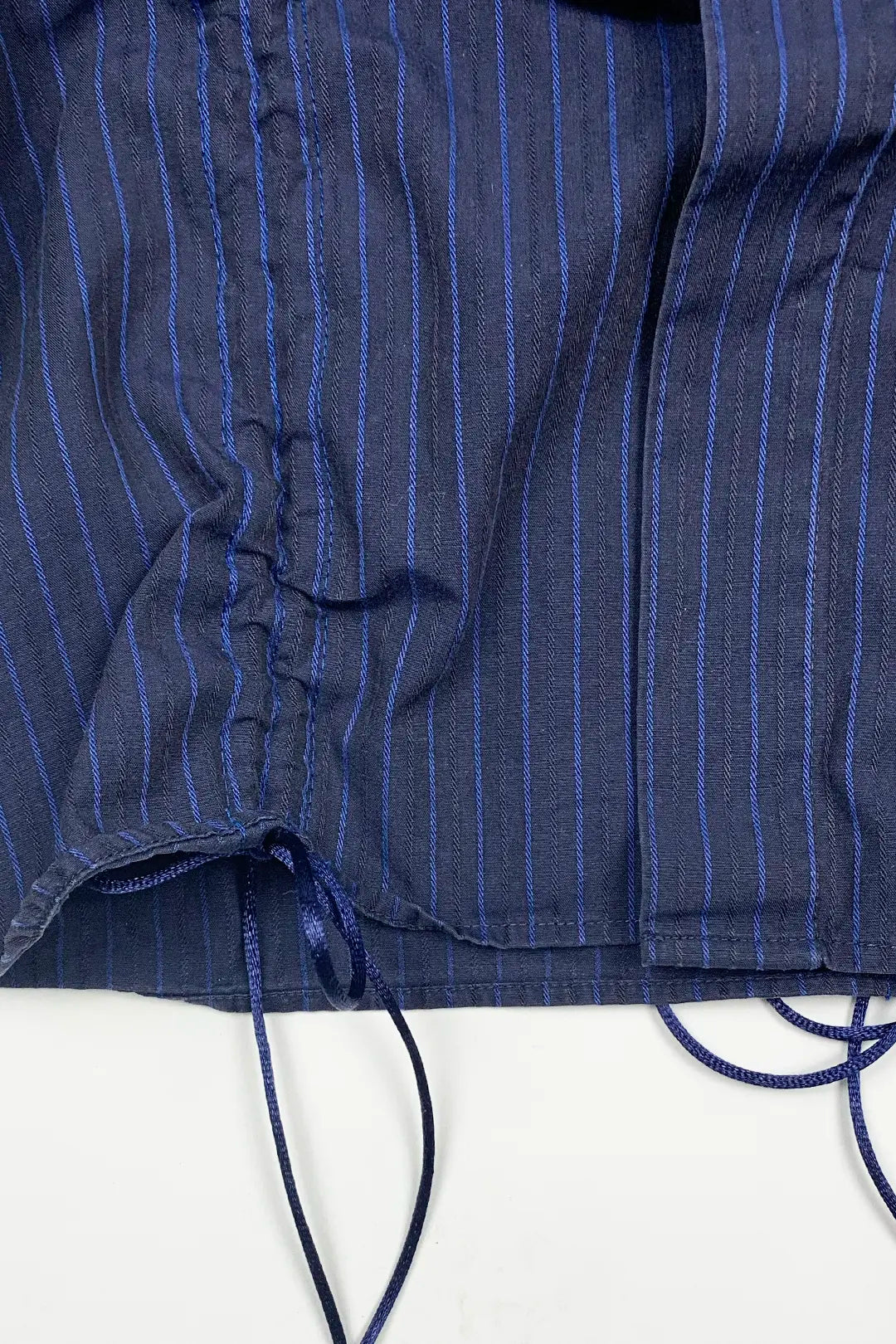 Close-up of a blue pinstripe shirt with a white background