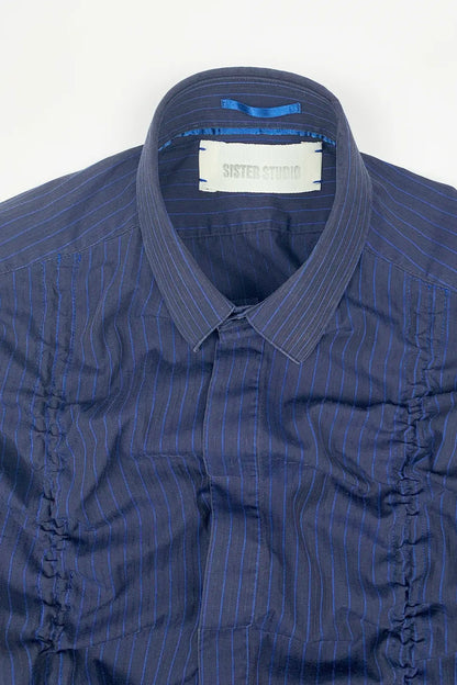 Blue striped shirt with SISTER STUDIO brand label on a white background
