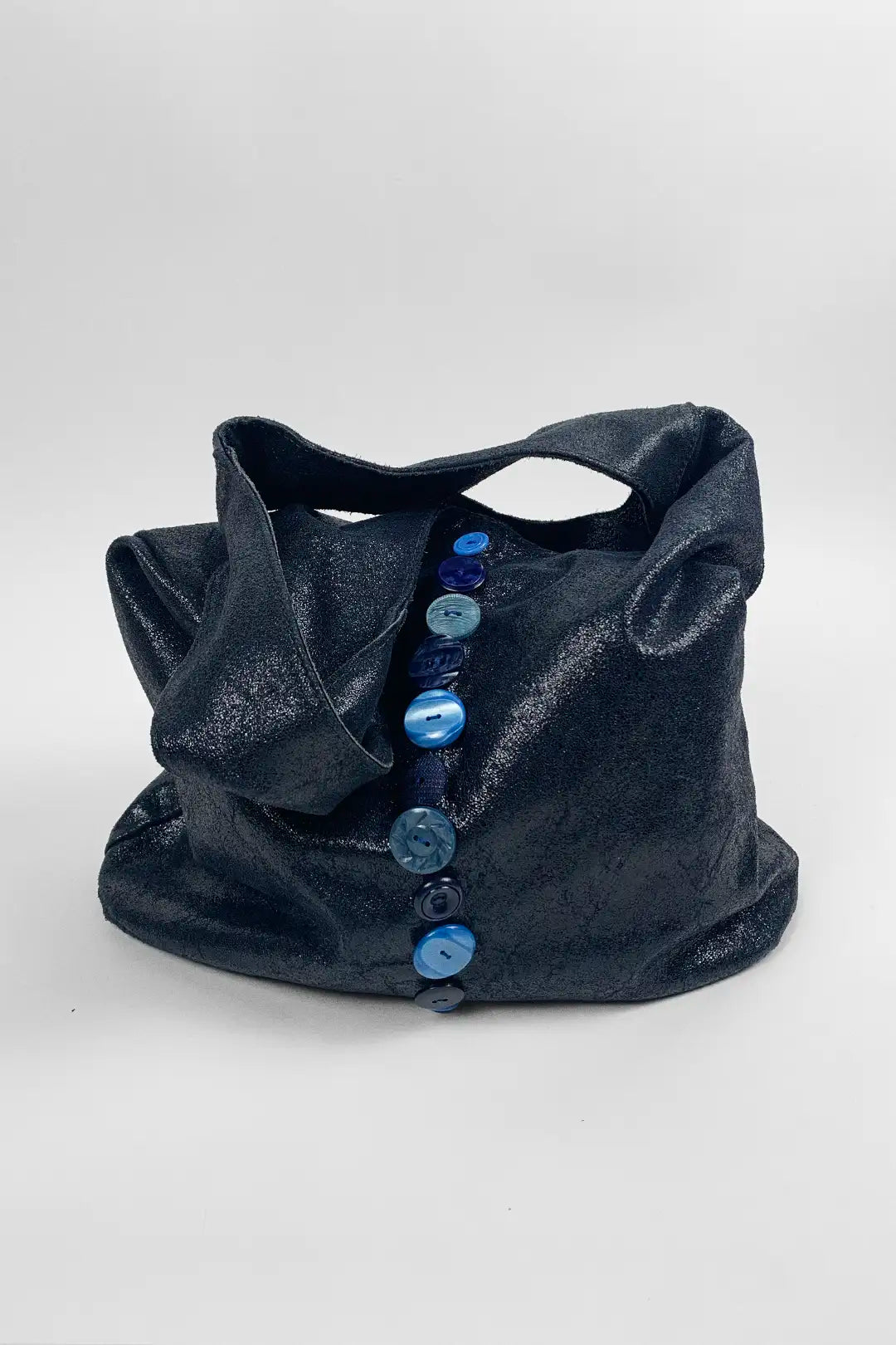 navy leather bag with blue buttons on a white background