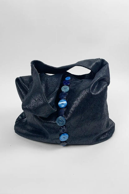 navy leather bag with blue buttons on a white background
