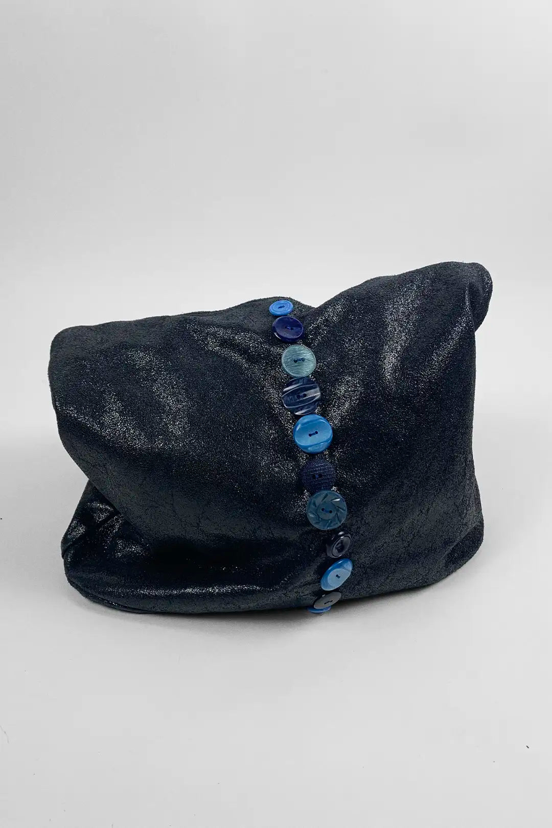 navy leather bag with blue button details on a white background
