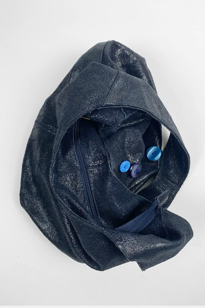 top view of navy leather bag with blue buttons on a white background