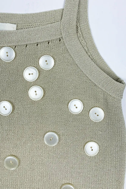beige tank top with button details on a white background, detail photo