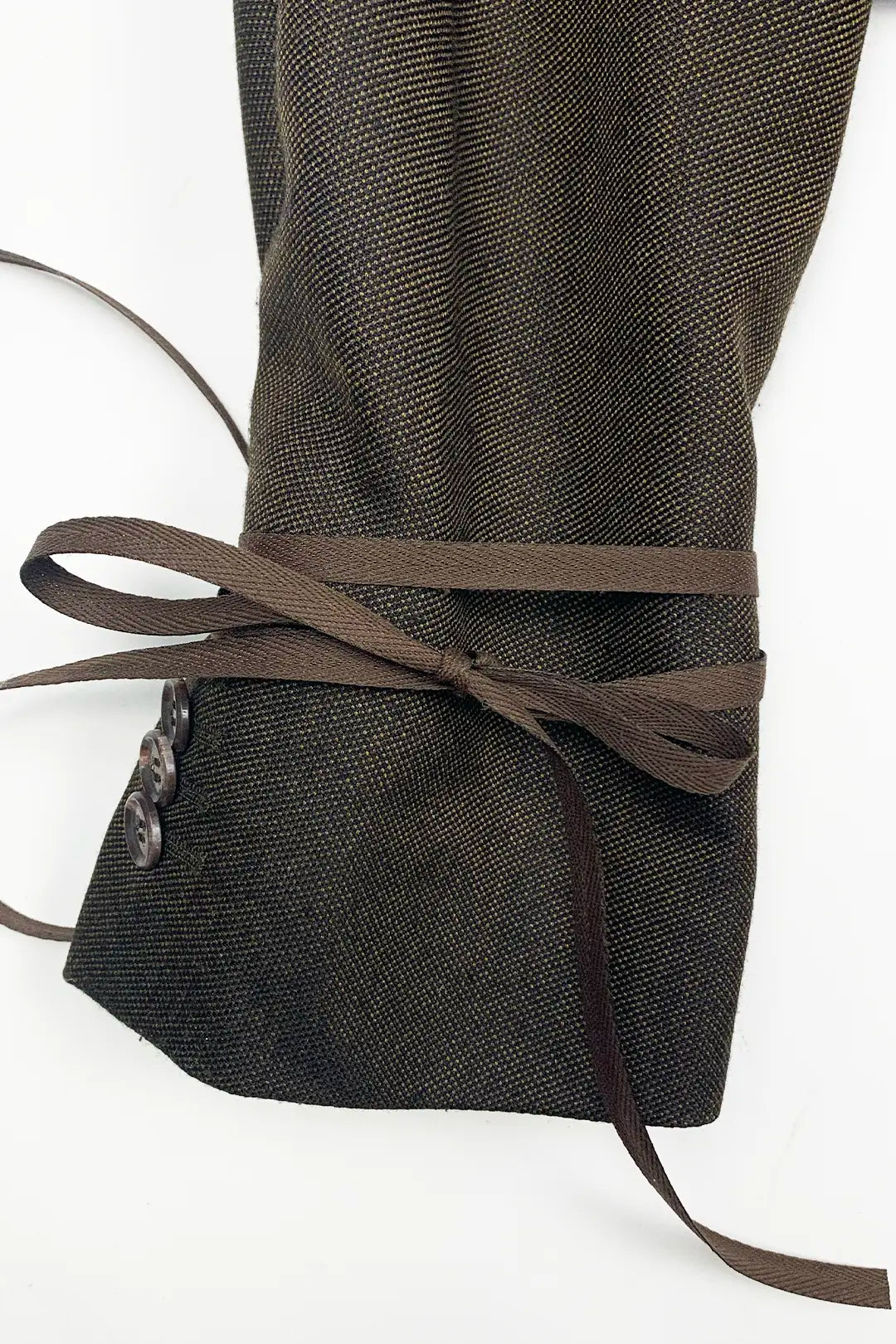 Dark brown wool sleve with a brown ribbon on a white background