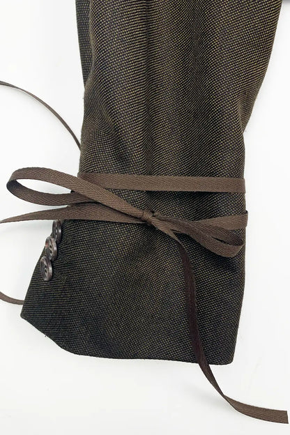Dark brown wool sleve with a brown ribbon on a white background